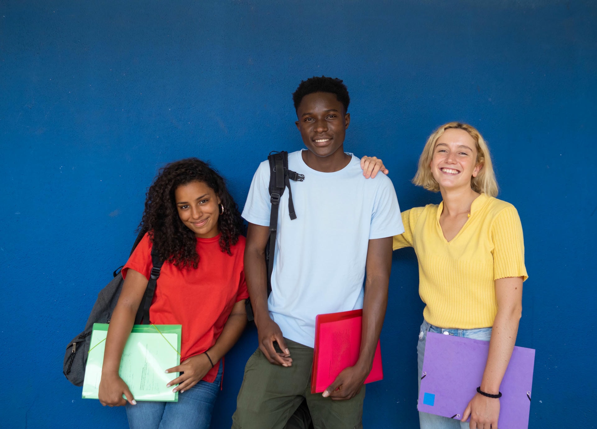 three-students-smiling-and-posing-in-front-of-wall-2026-01-07-07-14-53-utc